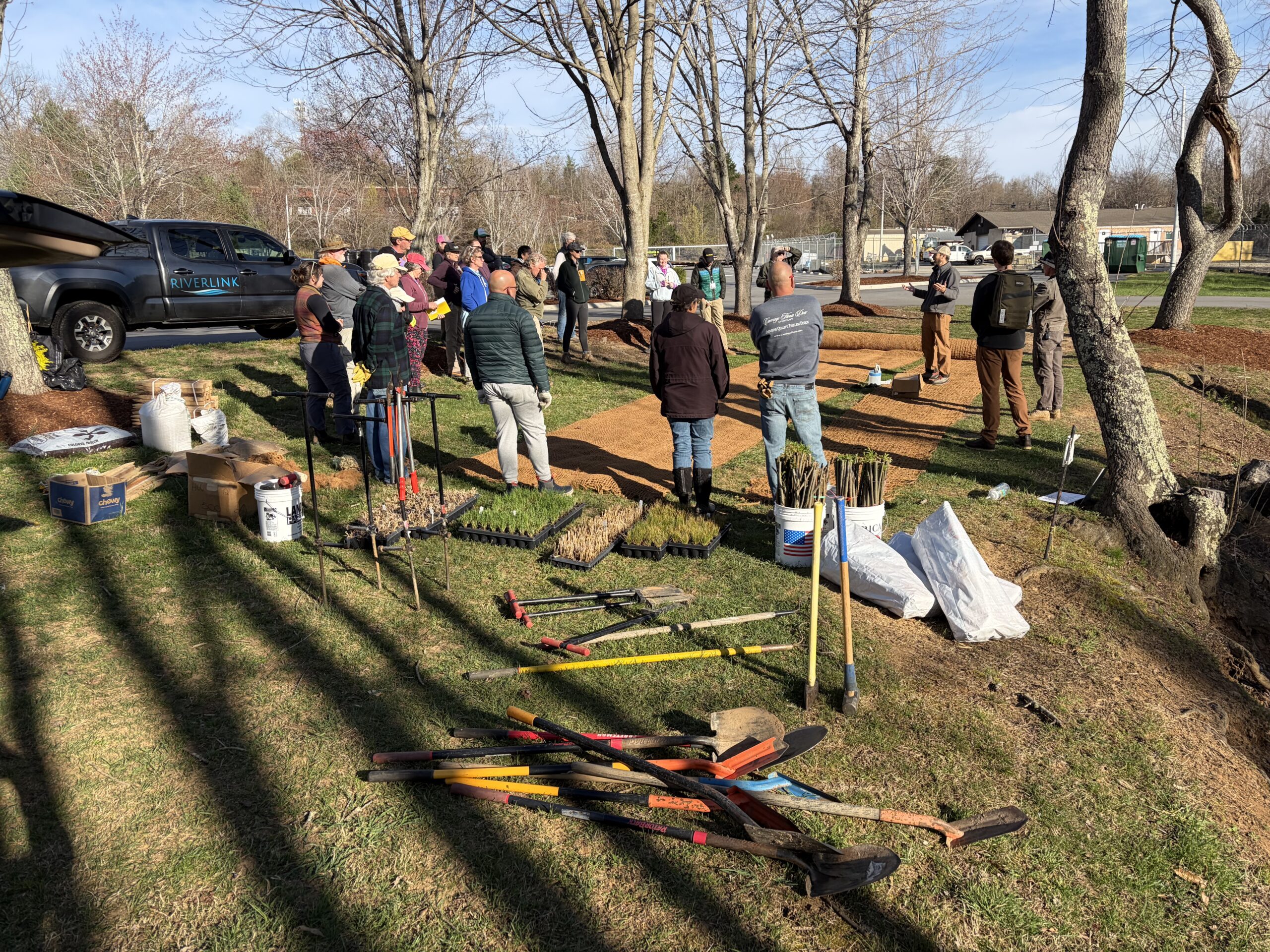 Trainees receive planting instruction with prepared sprouts, live stakes, and coir brush mattress