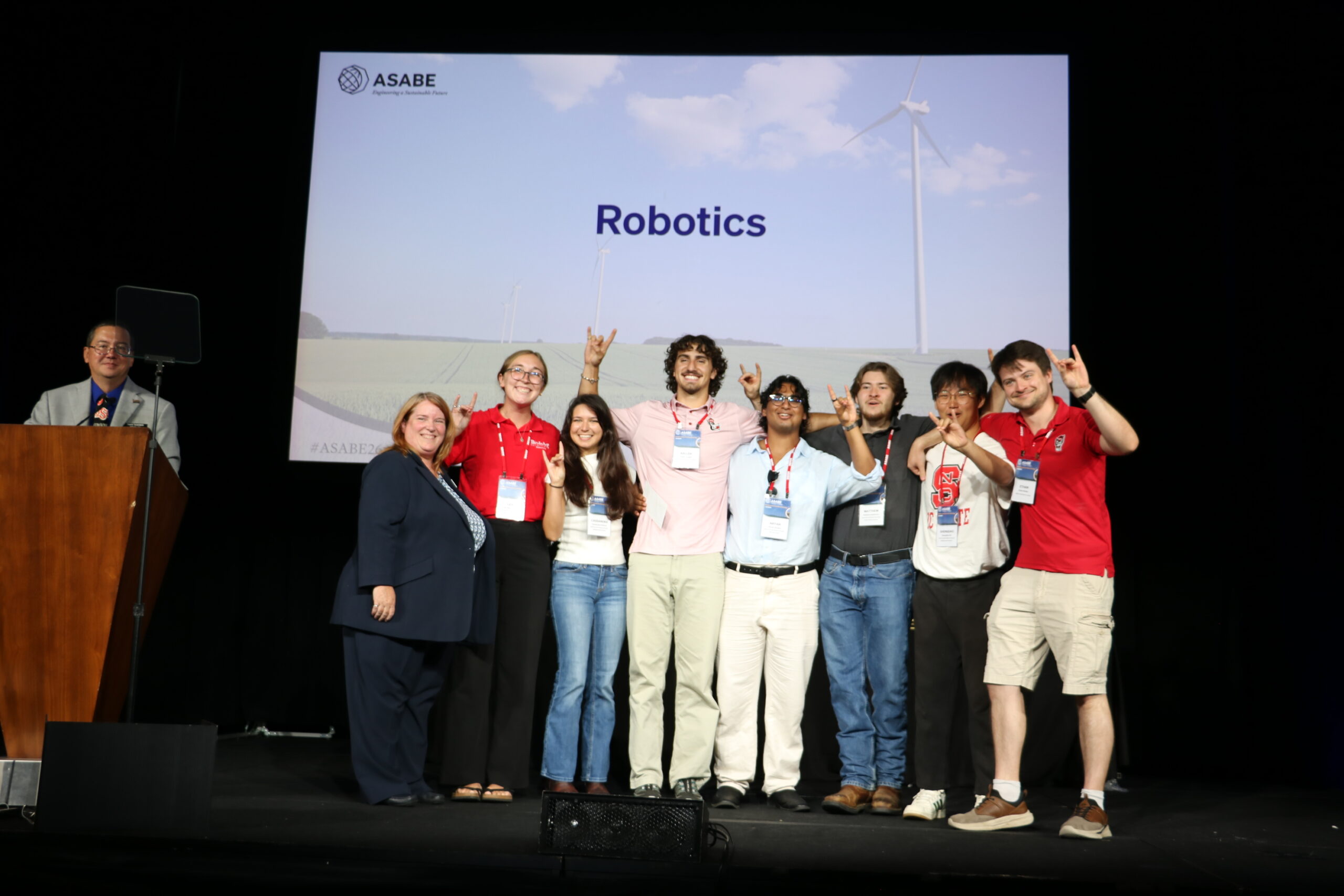 A student team accepts an award on stage.